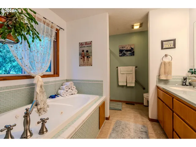 a bathroom with a sink mirror and a toilet