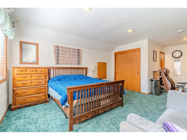 a bedroom with bed and window