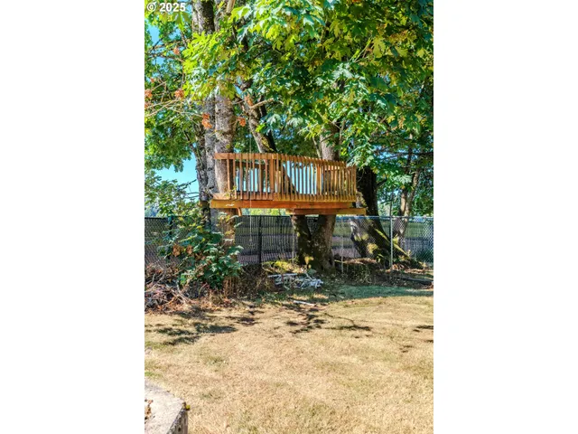 a view of outdoor space with deck and trees