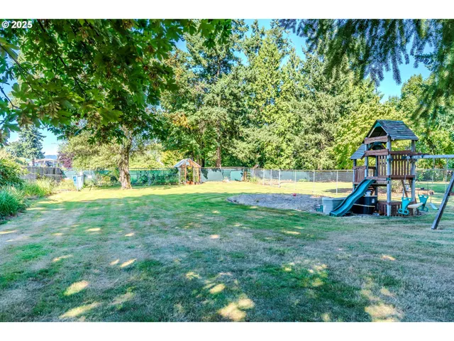 a view of a backyard with a garden and entertaining space