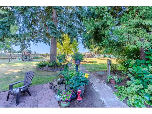 a view of green field with trees in the background