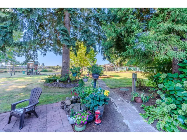 a view of green field with trees in the background