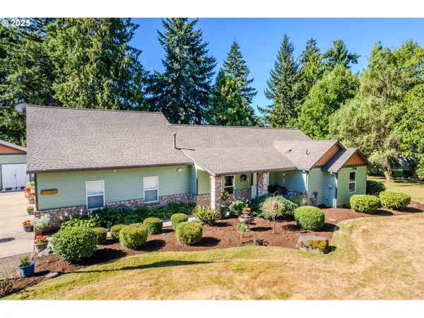 a view of a patio with table and chairs under an umbrella
