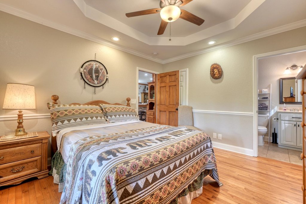 3204 Creekview Road Hiawassee, GA 30546 - Photo 14 of 45 a bedroom with a bed and a chandelier
