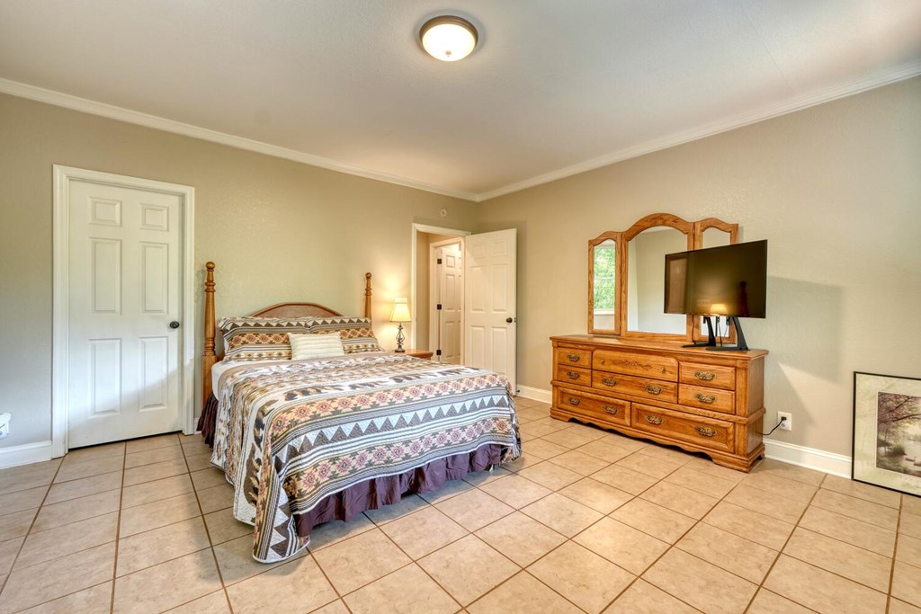 3204 Creekview Road Hiawassee, GA 30546 - Photo 28 of 45 a bedroom with a bed and a view of bathroom
