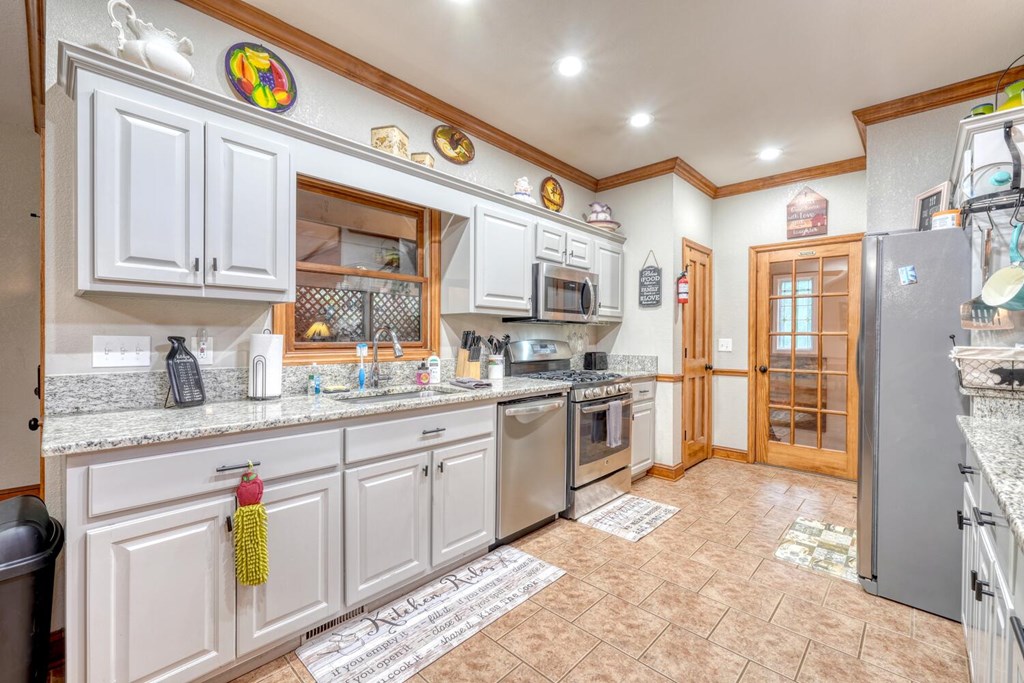 3204 Creekview Road Hiawassee, GA 30546 - Photo 5 of 45 a kitchen with stainless steel appliances granite countertop a refrigerator and a stove top oven
