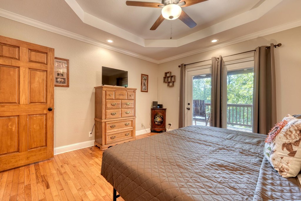 3204 Creekview Road Hiawassee, GA 30546 - Photo 7 of 45 a bedroom with a bed and a flat tv screen