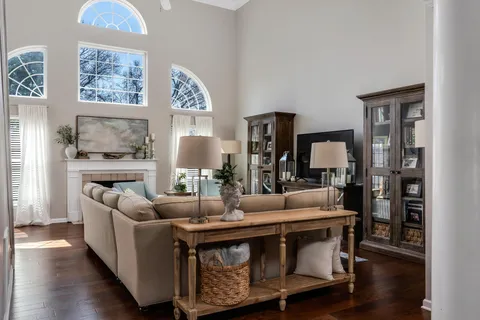 a living room with fireplace furniture and wooden floor