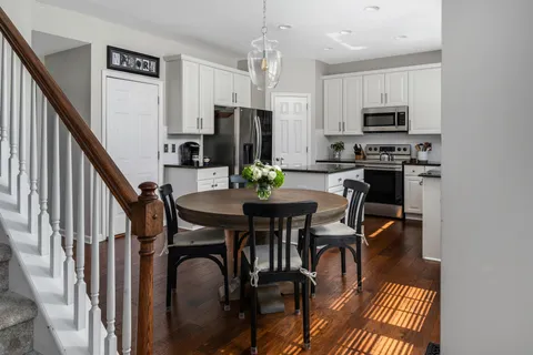 a view of a dining room with furniture and wooden floor