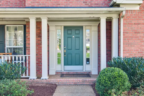 a front view of a house with a garden