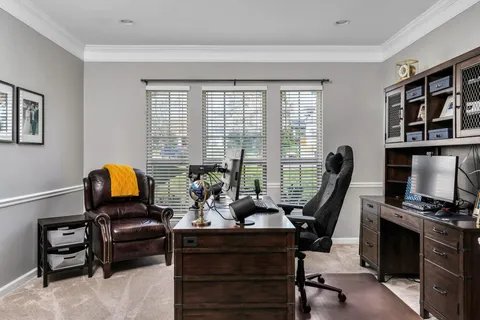 a living room with furniture stairs and a window