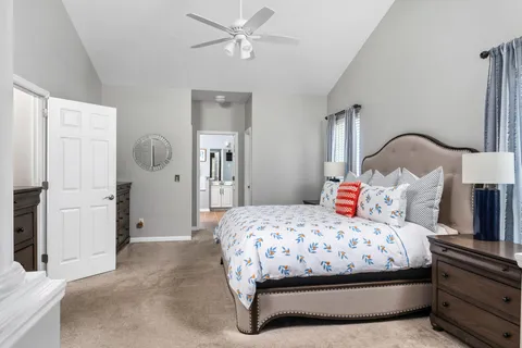 a bedroom with a bed and a chandelier
