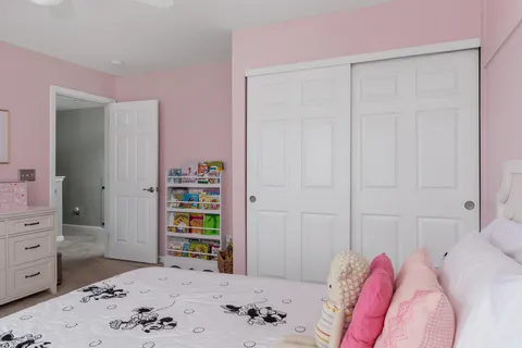 a bedroom with a bed and a dresser in it