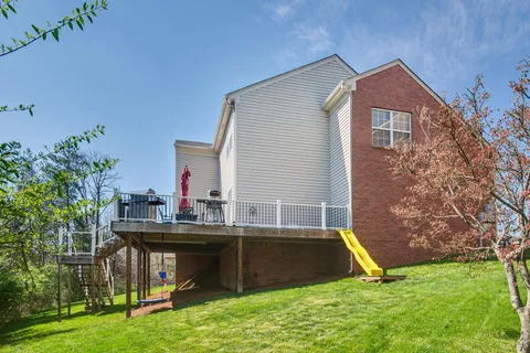 a view of pool with a yard