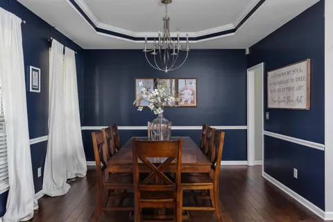 a view of a dining room with furniture and chandelier