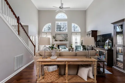 a living room with fireplace furniture and a large window