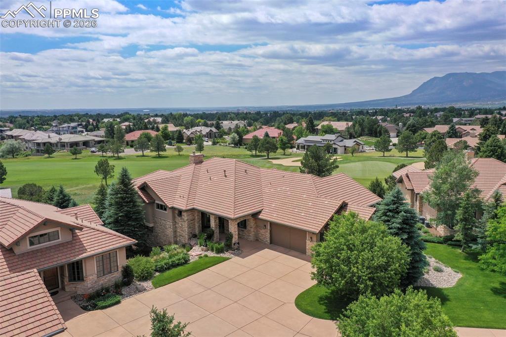 an aerial view of a house with garden space and outdoor seating