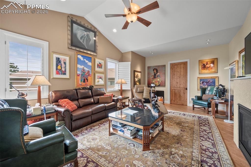 4025 Reserve Point Colorado Springs, CO 80904 - Photo 24 of 50 a living room with furniture a couch and paintings on the wall next to a window