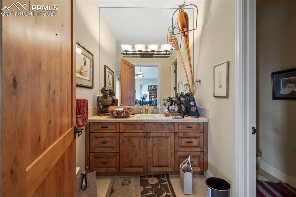 4025 Reserve Point Colorado Springs, CO 80904 - Photo 25 of 50 a bathroom with a sink vanity and mirror