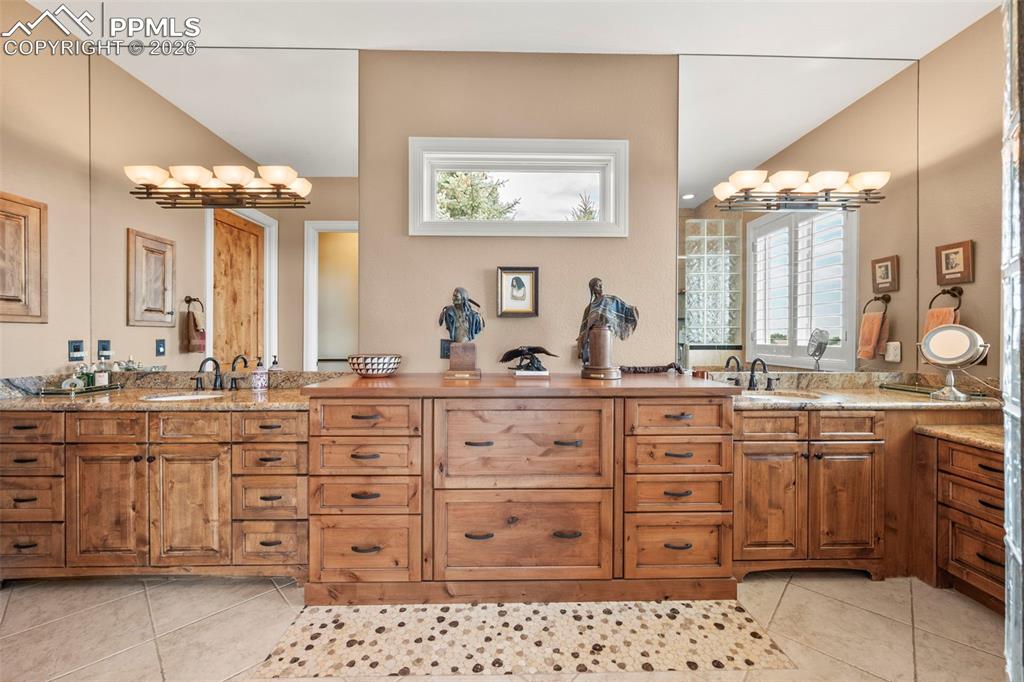 4025 Reserve Point Colorado Springs, CO 80904 - Photo 29 of 50 a bathroom with a granite countertop sink mirror and