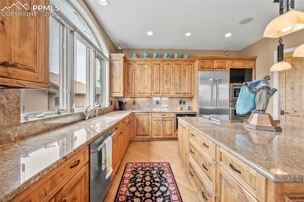 4025 Reserve Point Colorado Springs, CO 80904 - Photo 10 of 50 a large kitchen with granite countertop a large window