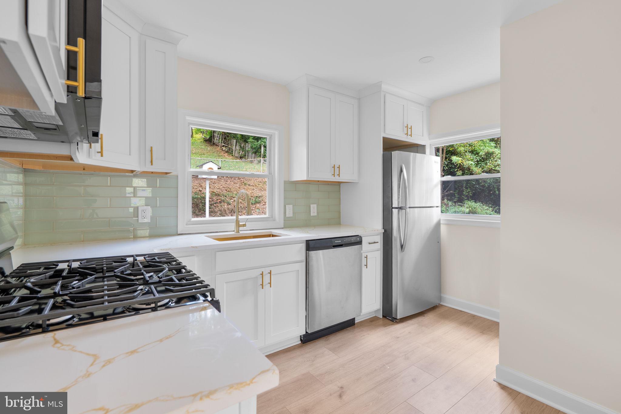 4205 Garrett Park Road Silver Spring, MD 20906 - Photo 12 of 41 a kitchen with sink a stove and refrigerator