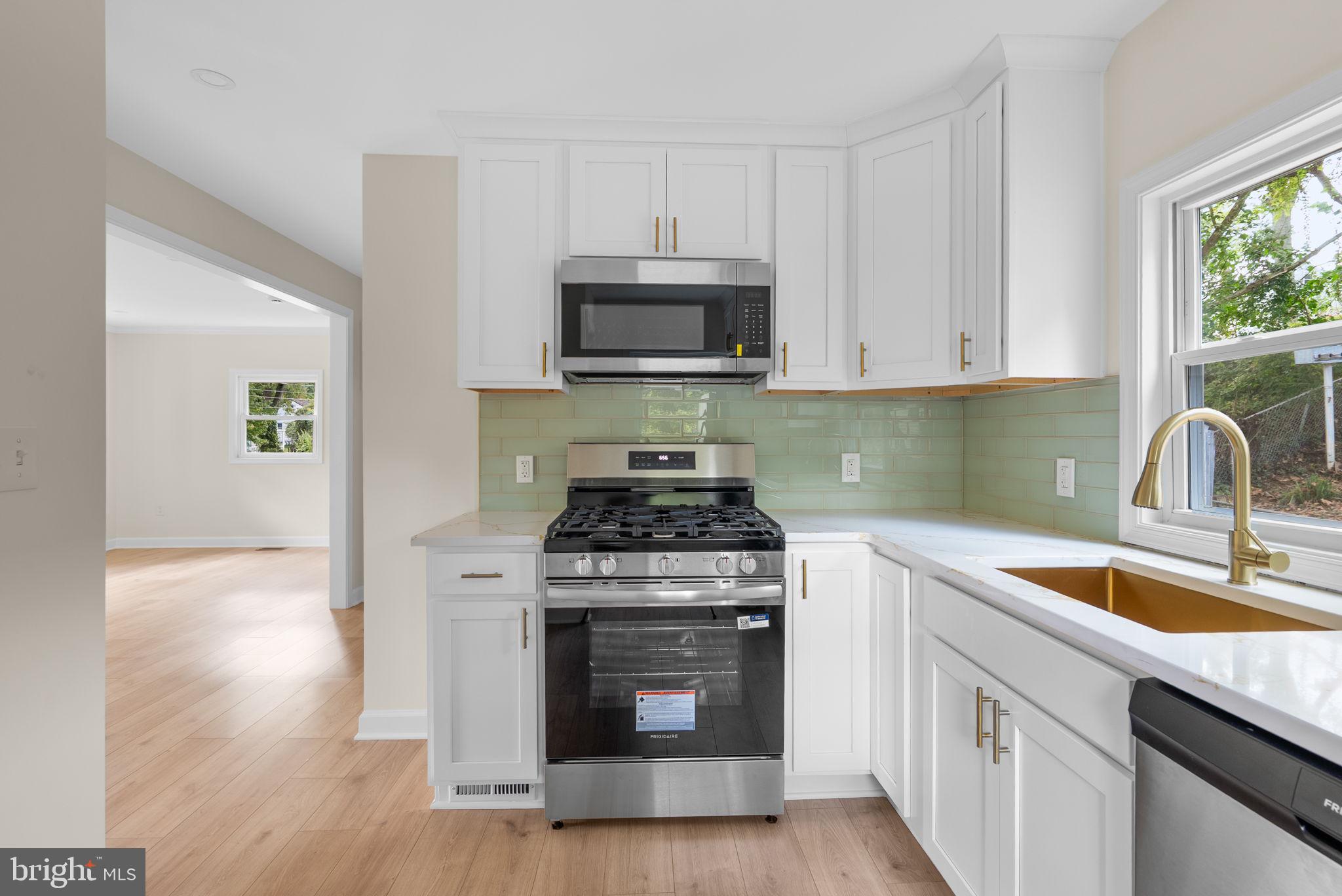 4205 Garrett Park Road Silver Spring, MD 20906 - Photo 14 of 41 a kitchen with a stove and a sink