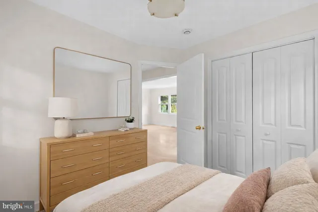 a bedroom with a bed and a mirror