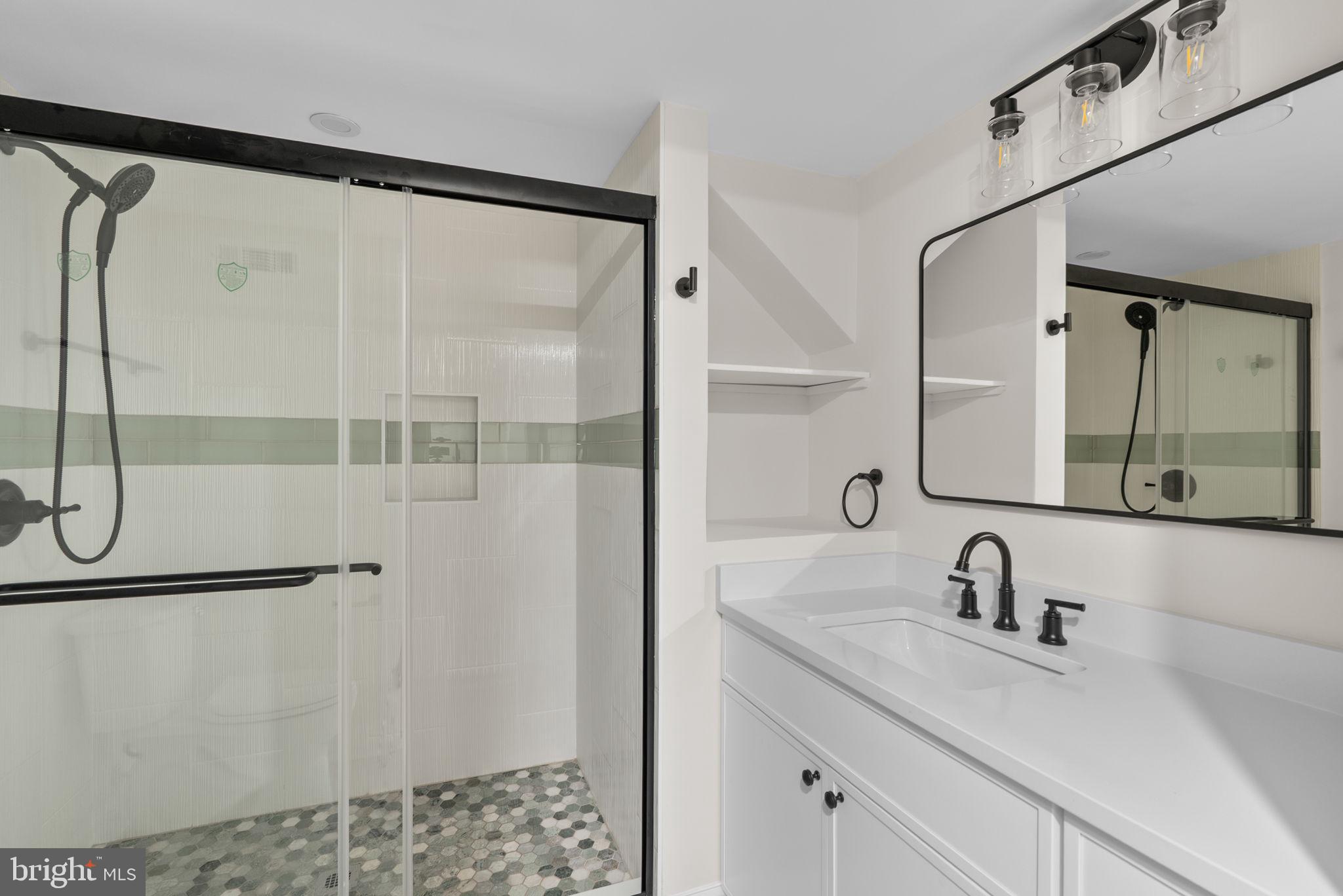 4205 Garrett Park Road Silver Spring, MD 20906 - Photo 26 of 41 a bathroom with a shower sink and mirror