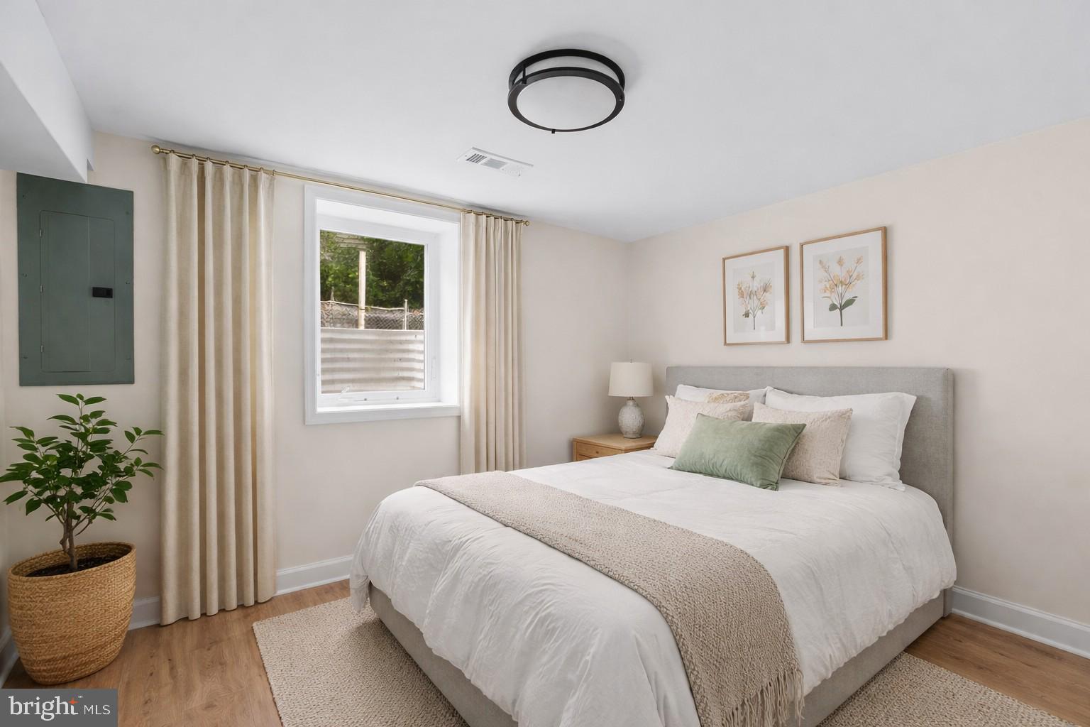 4205 Garrett Park Road Silver Spring, MD 20906 - Photo 27 of 41 a bedroom with a bed and a potted plant