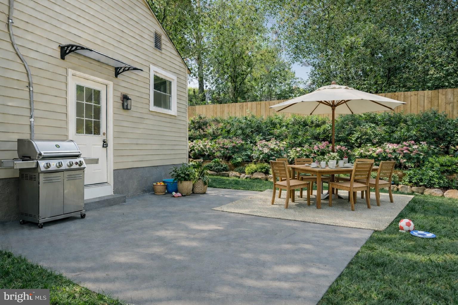 4205 Garrett Park Road Silver Spring, MD 20906 - Photo 34 of 41 a view of a patio with a table and chairs under an umbrella