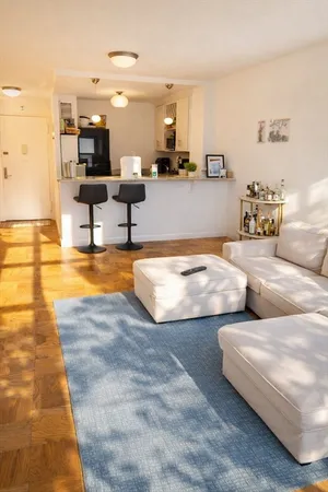 a living room with furniture and kitchen view