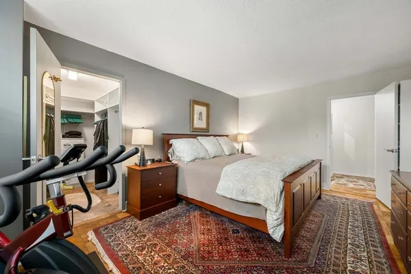 a bed room with a bed and a painting on the wall