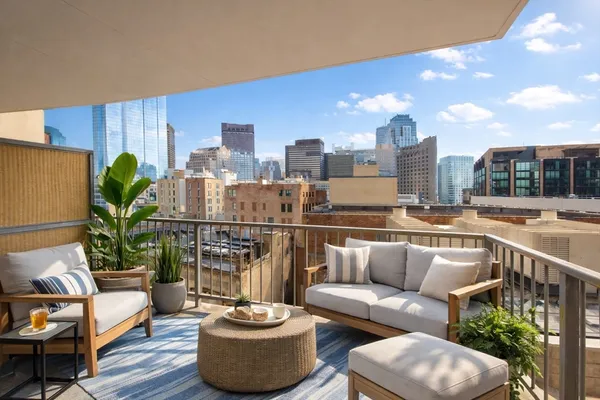a balcony with furniture and a potted plant