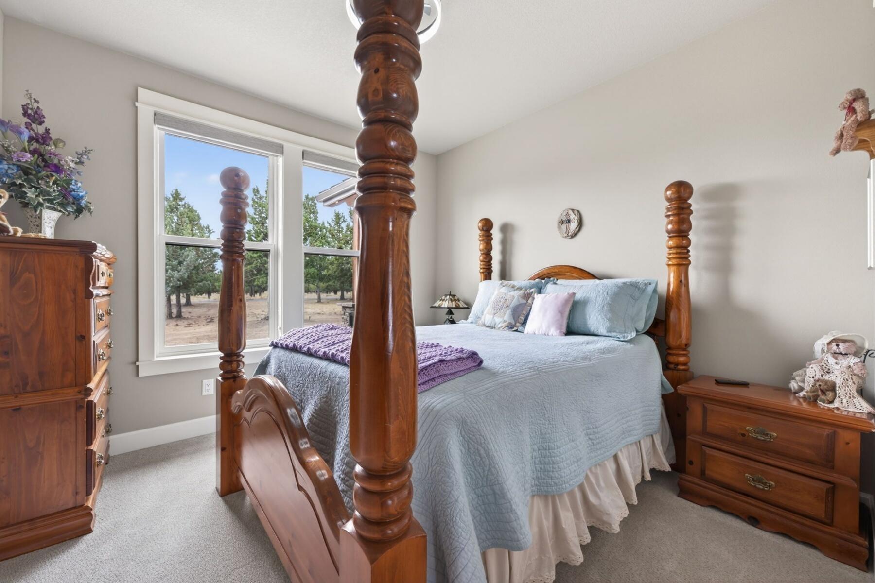 11620 Southwest Pixie Lane Culver, OR 97734 - Photo 28 of 53 a bedroom with a bed and a chandelier