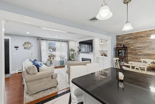 a living room with furniture wooden floor and a flat screen tv