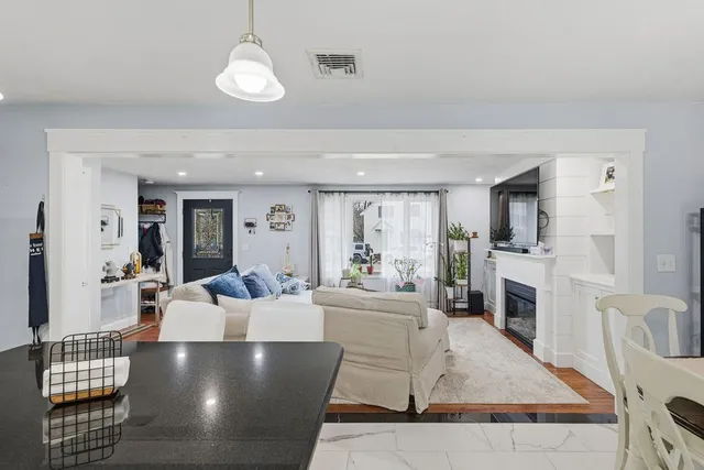 a living room with furniture wooden floor and a fireplace