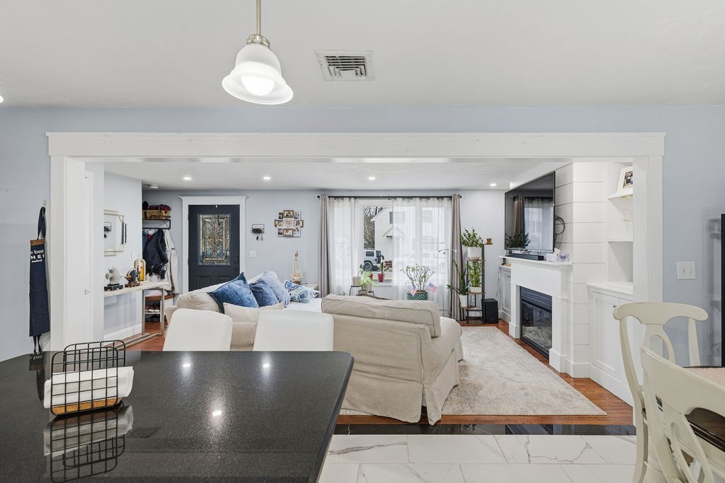 16 Perry Avenue, Unit 16 Taunton, MA 02780 - Photo 13 of 40 a living room with furniture wooden floor and a fireplace