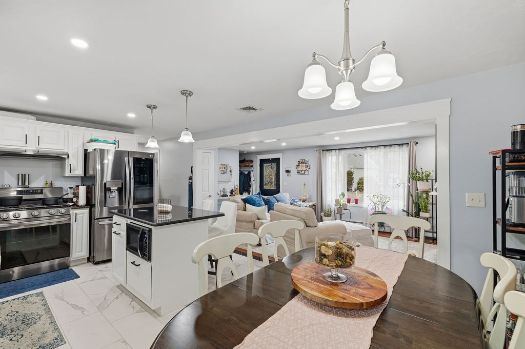 16 Perry Avenue, Unit 16 Taunton, MA 02780 - Photo 14 of 40 a view of a dining room with furniture a kitchen and chandelier