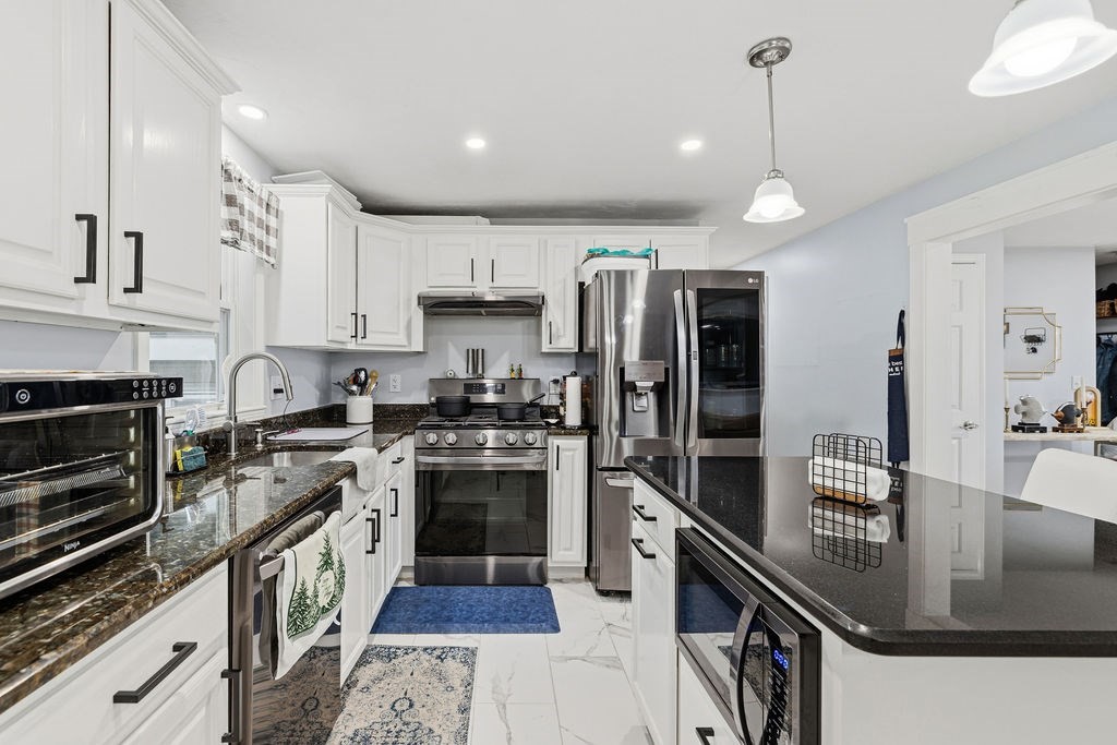 16 Perry Avenue, Unit 16 Taunton, MA 02780 - Photo 15 of 40 a kitchen with stainless steel appliances granite countertop a sink a stove and a refrigerator