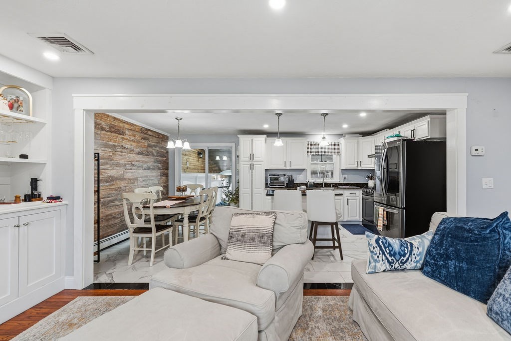16 Perry Avenue, Unit 16 Taunton, MA 02780 - Photo 16 of 40 a living room with furniture a rug and kitchen view