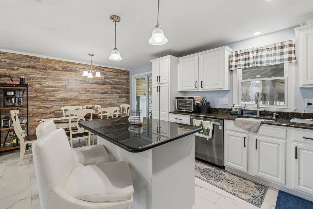 16 Perry Avenue, Unit 16 Taunton, MA 02780 - Photo 18 of 40 a kitchen with stainless steel appliances granite countertop a sink a stove and a wooden cabinets