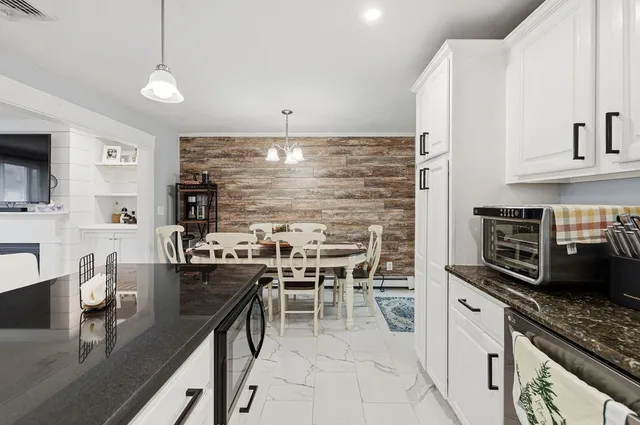 a kitchen with stainless steel appliances kitchen island granite countertop a sink and cabinets