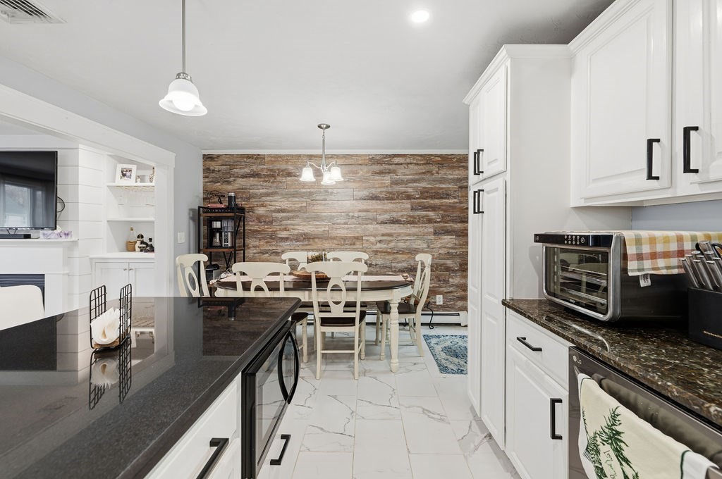 16 Perry Avenue, Unit 16 Taunton, MA 02780 - Photo 20 of 40 a kitchen with stainless steel appliances kitchen island granite countertop a sink and cabinets