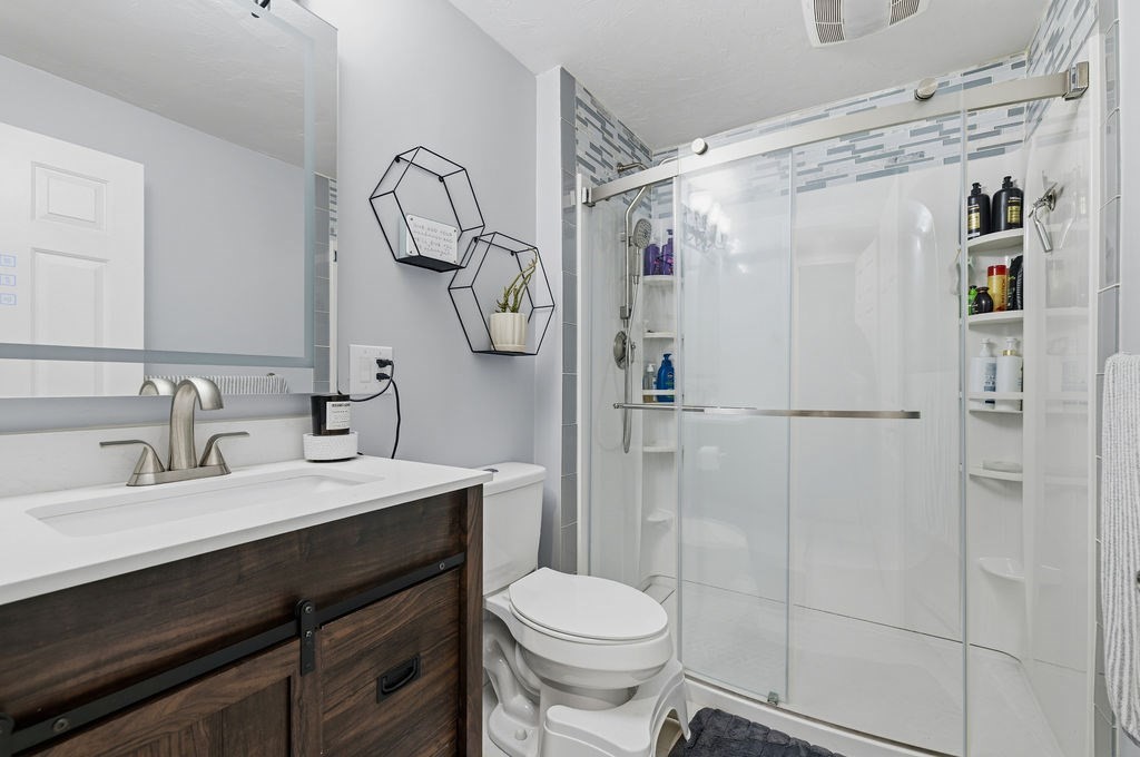 16 Perry Avenue, Unit 16 Taunton, MA 02780 - Photo 22 of 40 a bathroom with a sink vanity mirror and toilet