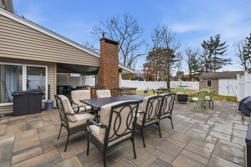 16 Perry Avenue, Unit 16 Taunton, MA 02780 - Photo 28 of 40 a view of a patio with table and chairs and potted plants