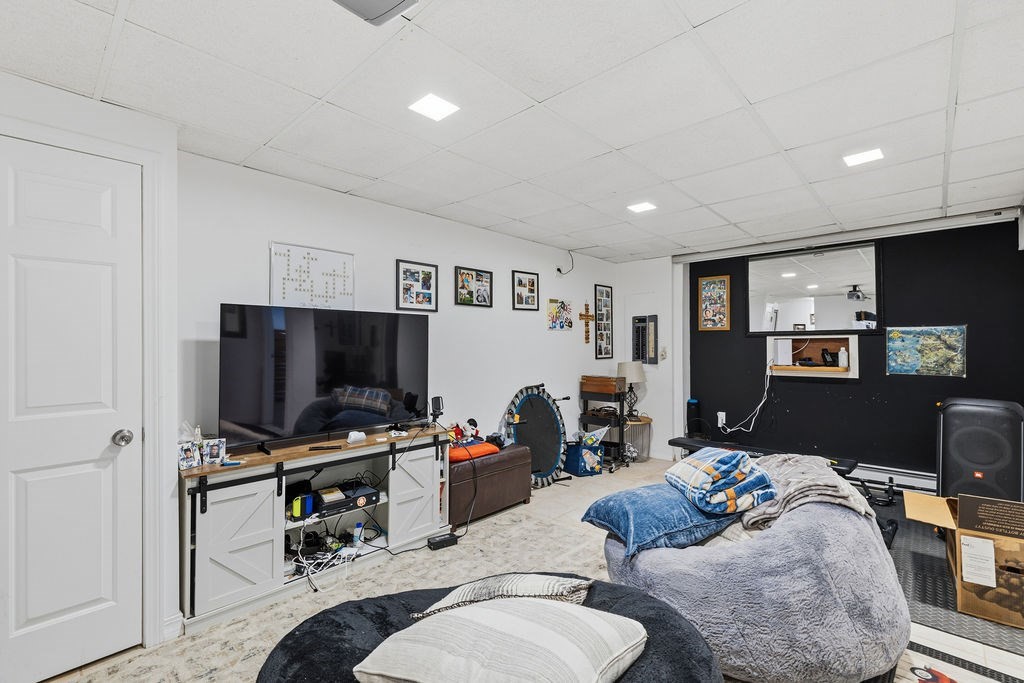 16 Perry Avenue, Unit 16 Taunton, MA 02780 - Photo 32 of 40 a living room with furniture and a flat screen tv