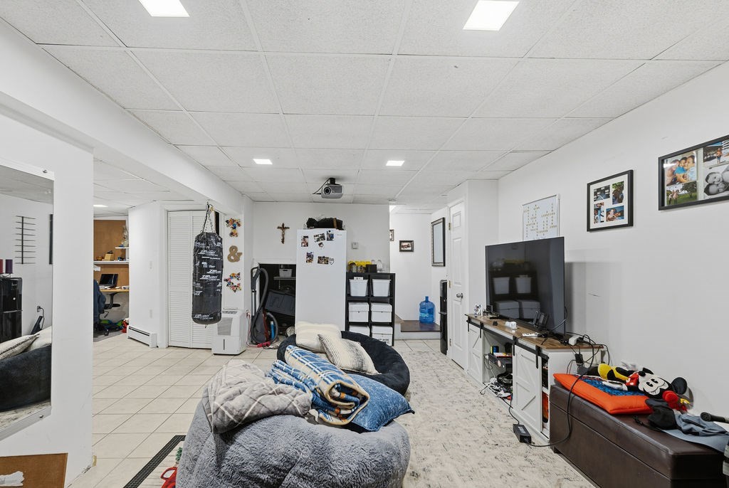 16 Perry Avenue, Unit 16 Taunton, MA 02780 - Photo 33 of 40 a room with furniture and a flat screen tv