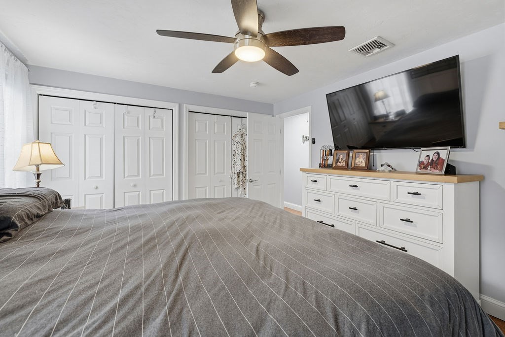 16 Perry Avenue, Unit 16 Taunton, MA 02780 - Photo 36 of 40 a bedroom with a bed and a flat screen tv