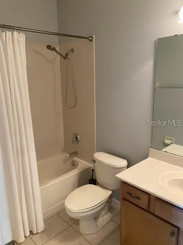 a white toilet sitting next to a bath tub